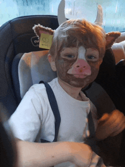 a child wearing a cow costume has a tag on his back that says 18