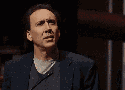 a man in a suit is making a funny face and says `` how absurd '' .