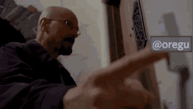 a man pointing to a sign that says @oregu