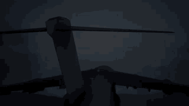 a large military plane is flying through the air