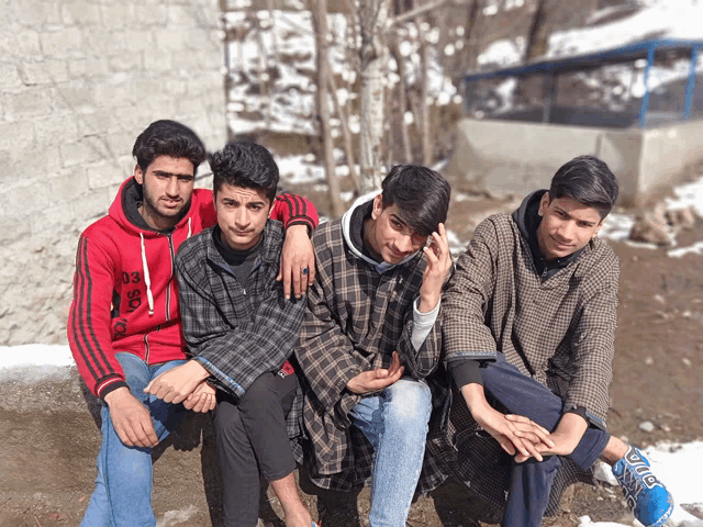 a group of young men posing for a picture with one wearing a red jacket that says ds