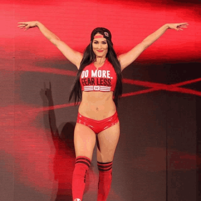 a female wrestler wearing a red top that says do more fearless