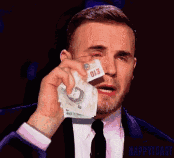 a man in a suit and tie is crying while holding a piece of money with the number 013 on it