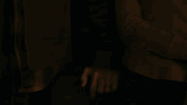 a close up of a person 's hand with a ring on it