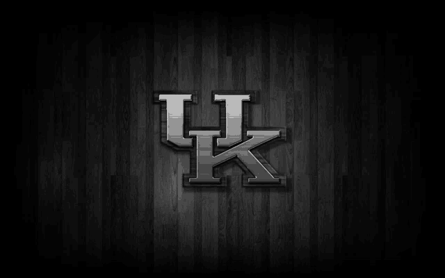 the kentucky basketball logo is on a wooden background .