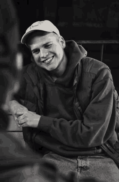 a man wearing a hat that says " i love " smiles for the camera