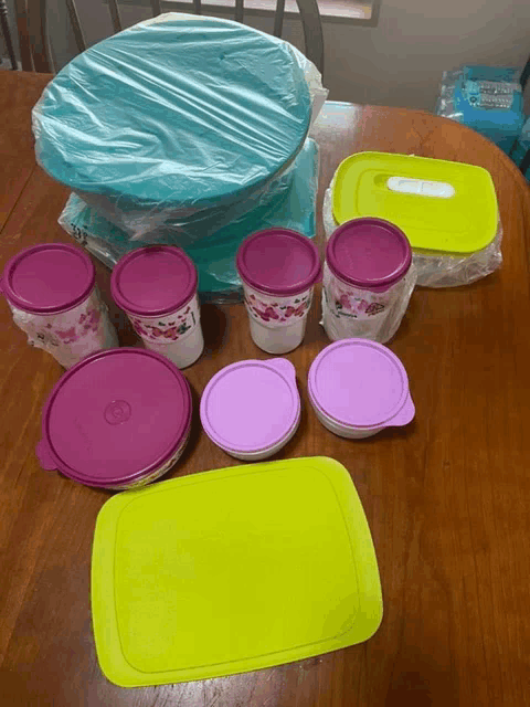 a bunch of plastic containers on a table with one that says tupperware