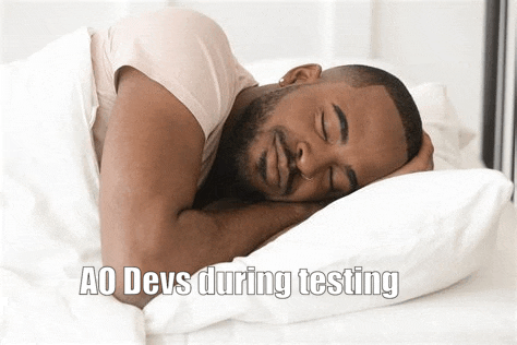 a man is sleeping on a bed with his eyes closed and a caption that says ao devs during testing .