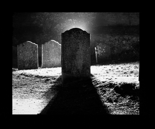 a black and white photo of a cemetery