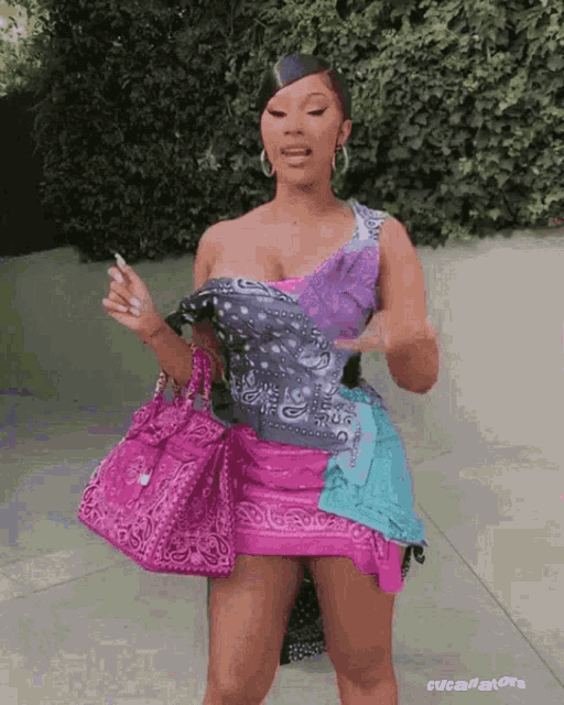 a woman in a pink dress is holding a pink bandana