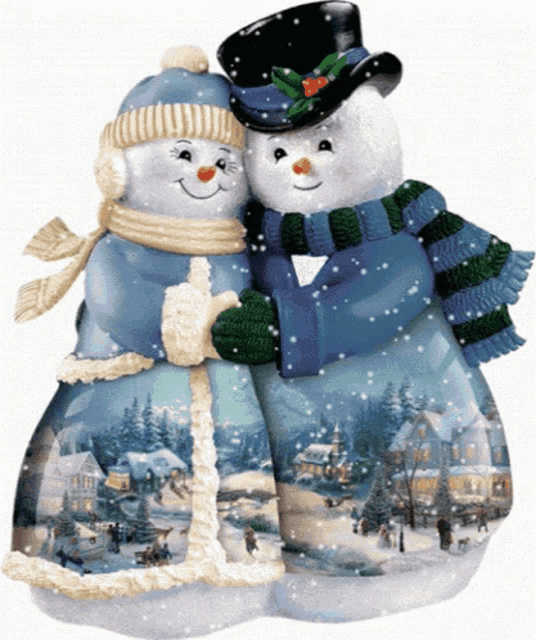 a couple of snowmen standing next to each other in a snowy scene