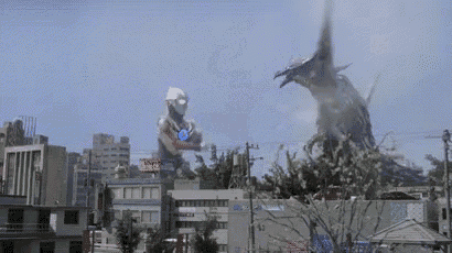 a giant monster is flying over a city in the sky .