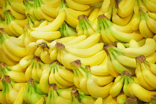 a bunch of bananas with green stems are stacked together