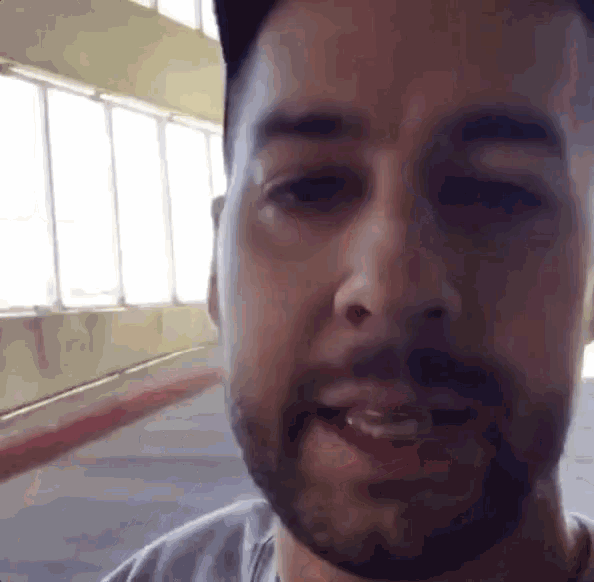 a close up of a man 's face with a beard and hat