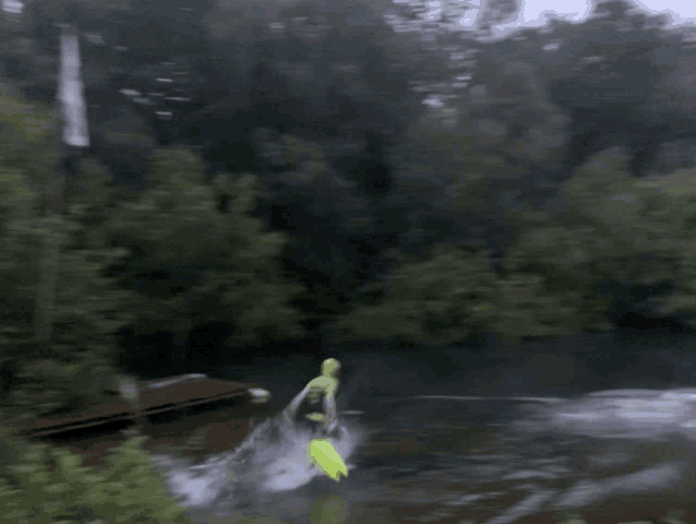 a blurred image of a person jumping into a river