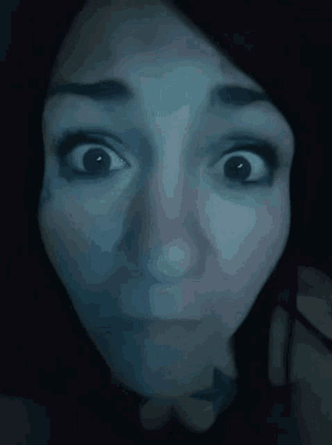 a close up of a woman 's face with her eyes looking up