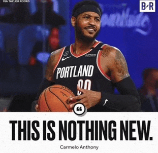 a basketball player from portland is holding a basketball in his hands