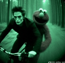 a man riding a bike with elmo on the back