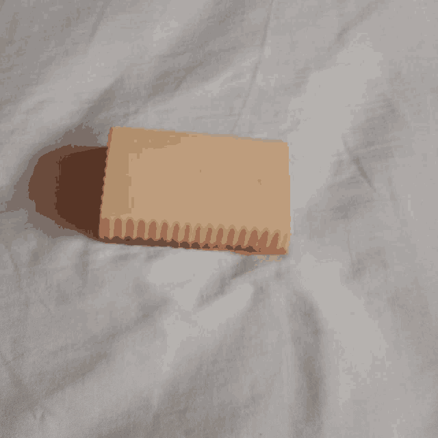 a soap bar is sitting on a white blanket