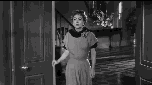 a black and white photo of a woman in a fur collar