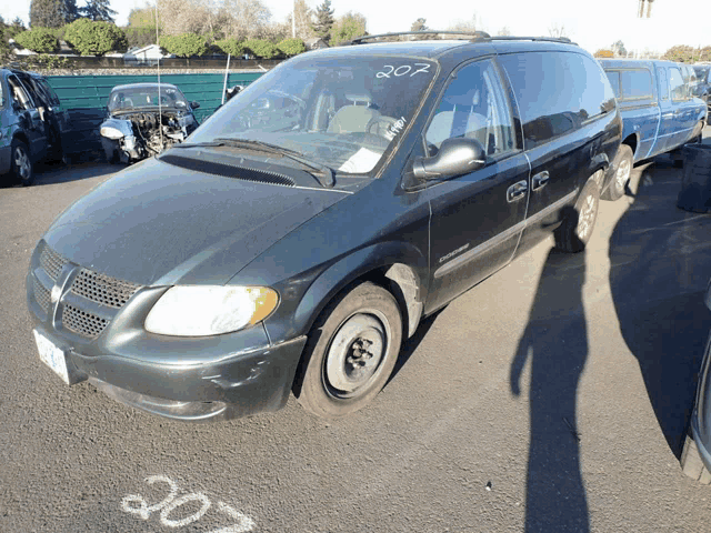 a green dodge minivan with the number 207 on the front