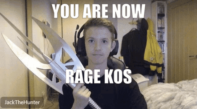 a boy wearing headphones is holding a sword that says " you are now rage kos " on it