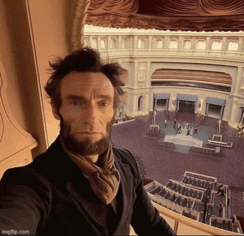 a man with a beard is taking a selfie in front of a large building