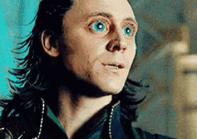 a close up of a man 's face with big blue eyes .