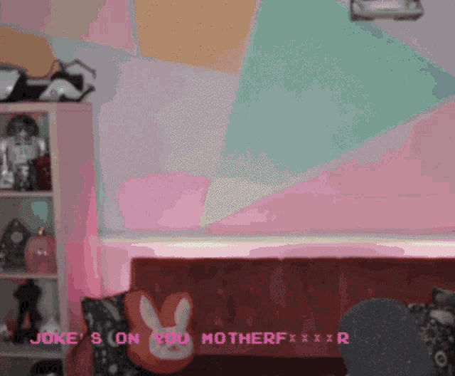 a woman sitting on a couch with a bunny pillow and the words joke 's on you motherfxxxr