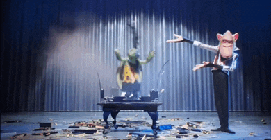 a man in a pig mask stands in front of a table with a turtle on it