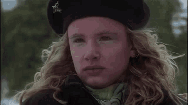 a close up of a woman wearing a beret