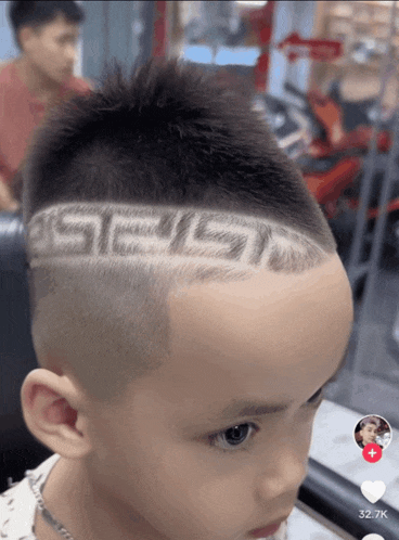 a young boy with a greek key design on his head