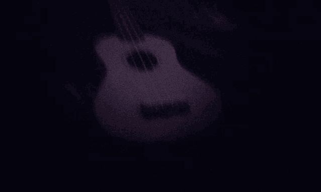 a pink guitar is sitting in the dark with a black background