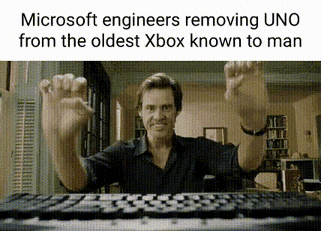 a man is sitting at a keyboard with his hands in the air and a meme about microsoft engineers removing uno