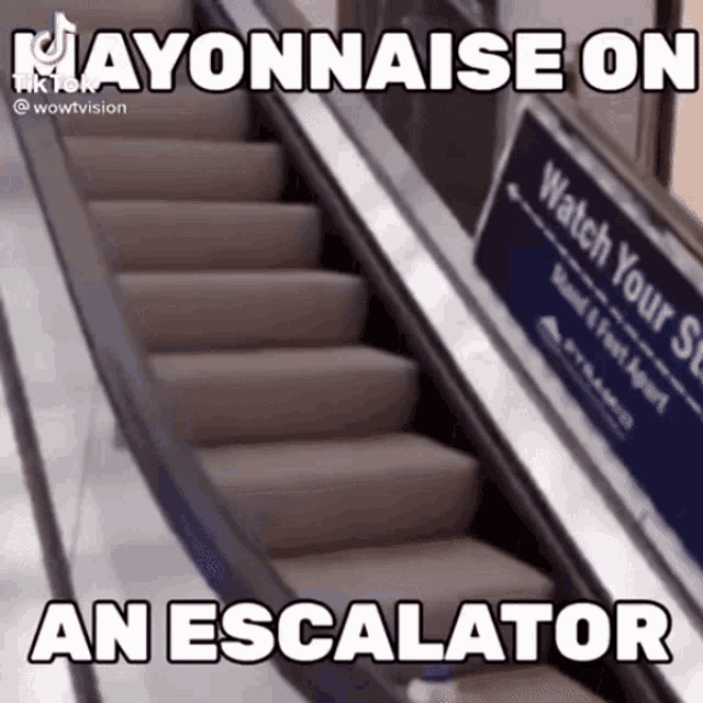 an escalator with a sign that says watch your step