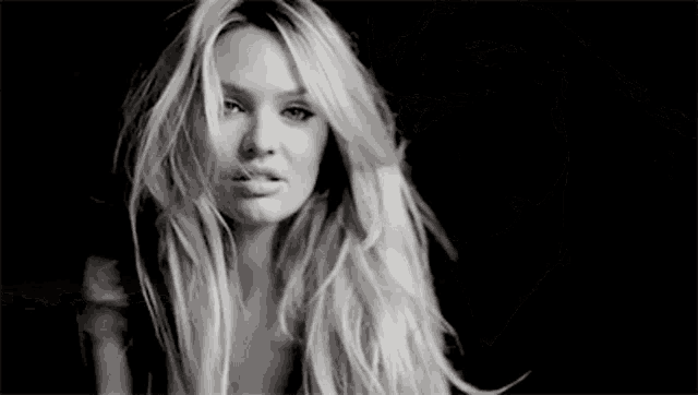 a black and white photo of a woman 's back and shoulder .