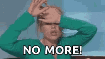 a woman in a green sweater is covering her face with her hands and says `` no more '' .