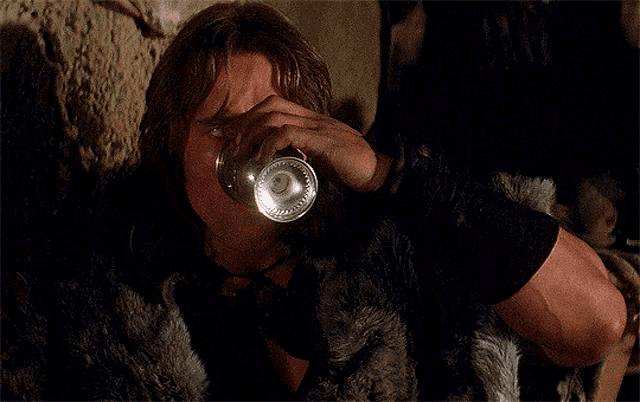 a man in a fur coat drinks from a glass with the words wtf written below him