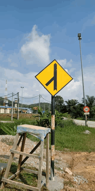 a yellow sign with a black arrow points to the right