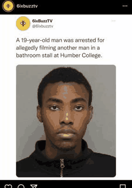 a young man was arrested for allegedly filming another man in a bathroom stall at humber college .