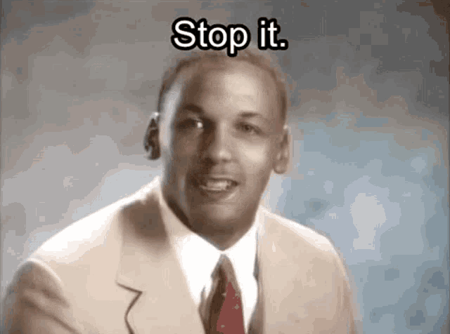 a man in a suit and tie is talking and says stop it .