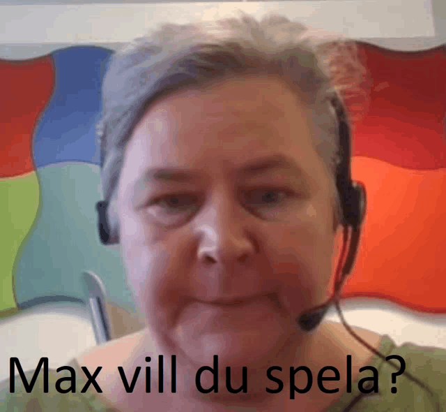 a woman wearing a headset has the words max vill du spela written on her face