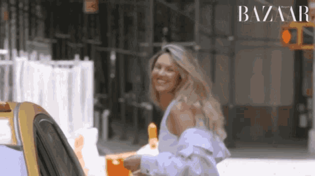 a woman is getting out of a taxi with the word bazaar written on the bottom