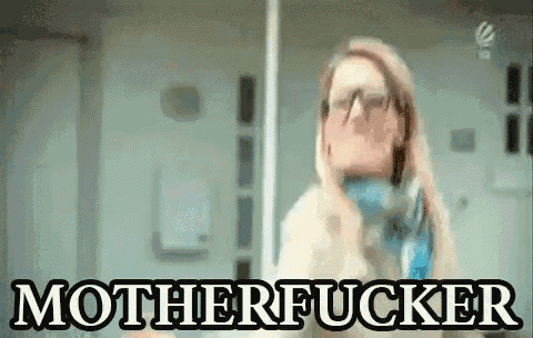 a woman with glasses says motherfucker in front of a mirror