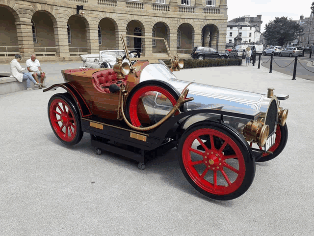 a silver and red car with a license plate that says ' b17 ' on it