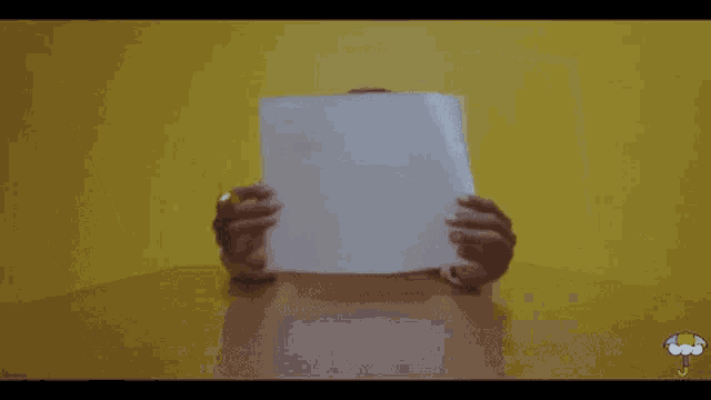 a person holding a piece of paper that says artist aren 't slaves