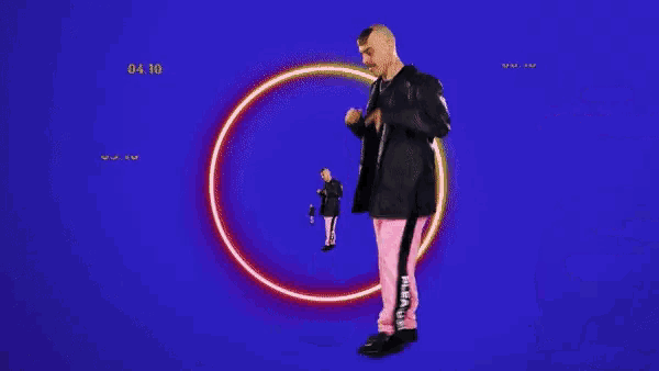 a man in a black jacket and pink pants is dancing in front of a neon circle .