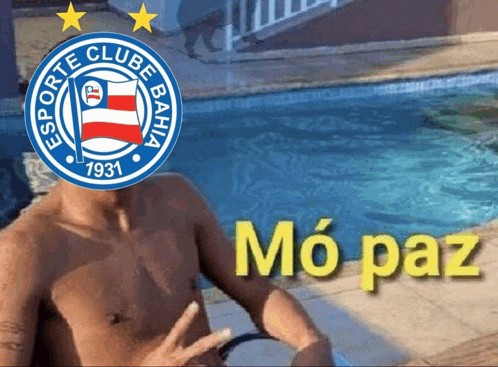 a shirtless man sits in front of a pool with a logo for esporte clube bahia on his head