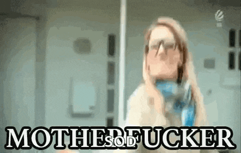 a woman wearing glasses and a scarf is standing in front of a sign that says motherfucker .