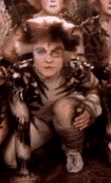 a group of people are posing for a picture . one of the people is wearing a pirate hat .